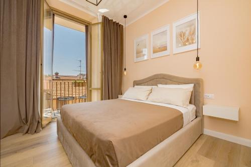 a bedroom with a large bed and a balcony at Visconti Apartment by Rhospitality it in Rho