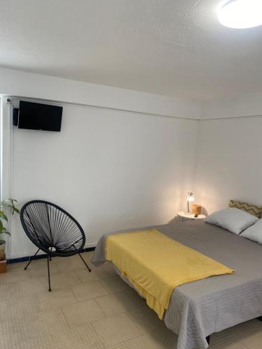 a bedroom with a bed and a tv on the wall at Quarto, Algarve in Olhão