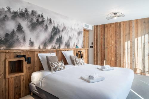 a bedroom with a large white bed with wooden walls at Logis Hotel la Résidence in Le Val-dʼAjol