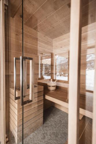 a small bathroom with a sink and a window at Borgo Antico Mountain Lodge in Sappada