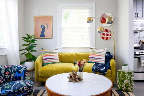 a living room with a yellow couch and a table at Prospect in Atlanta