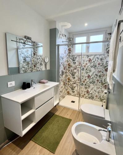 a bathroom with a sink and a shower at The Cozy Peak - 360 Dolomites View in Agordo