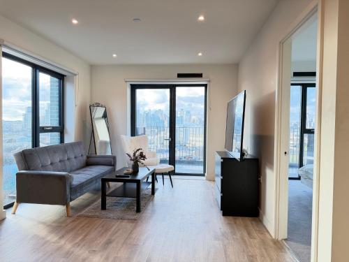 a living room with a couch and a table at Silver Apartments ExCel in London