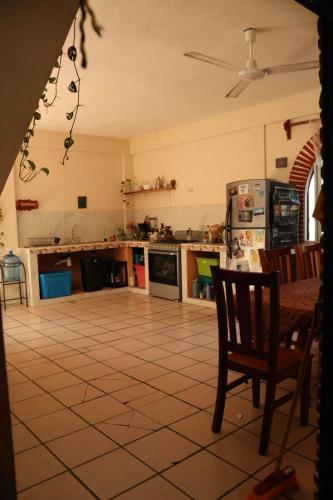 a kitchen with a table and a chair in it at El jardin in Brisas de Zicatela