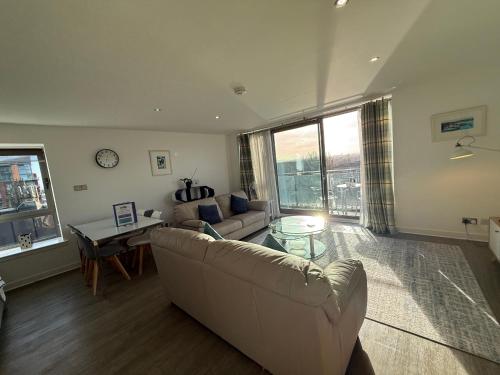 a living room with a couch and a table at Principal Apartments - Clyde Waterfront Apartments in Glasgow