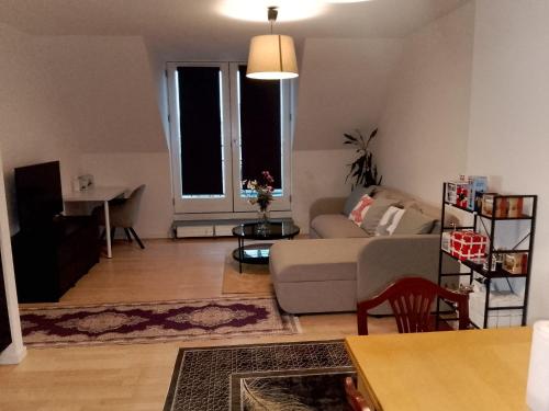 a living room with a couch and a table at Metro Apartment Linde Alle 14, 3Th 2720 Vanløse in Copenhagen