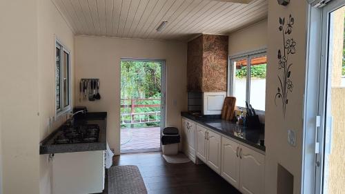 a kitchen with a sink and a counter top at Araucária Lodge - 800 metros do Capivari in Campos do Jordão