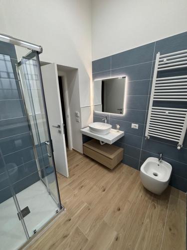 a bathroom with a sink and a toilet and a mirror at Notte di note in Pagani