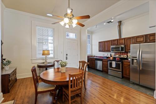 a kitchen with a wooden table and a refrigerator at Grenoble House in New Orleans
