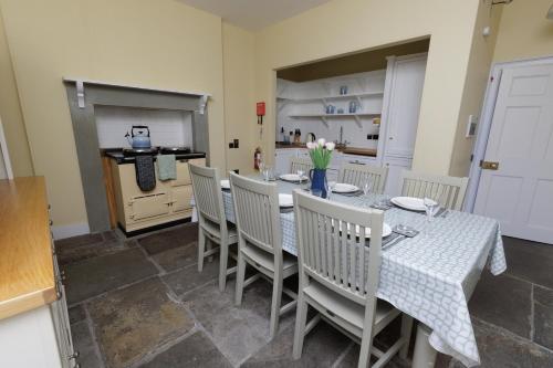 a kitchen and dining room with a table and chairs at Principal Keeper's Cottage at Sumburgh Lighthouse, Shetland Islands in Sumburgh