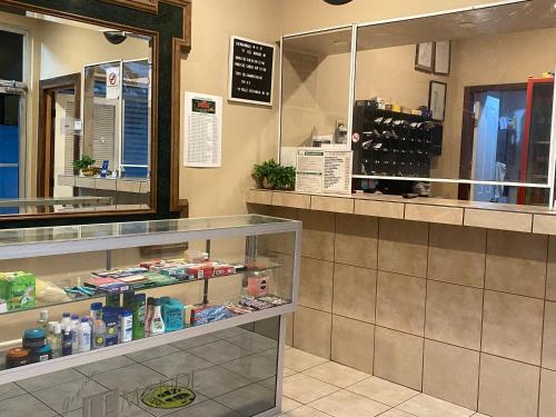 a restaurant with a counter with a display case at Hotel Del Bosque in Tijuana
