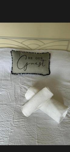 a bed with a pillow that says be our guest at Conner house in Middlesbrough