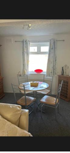 a dining room with a table and chairs and a window at Conner house in Middlesbrough