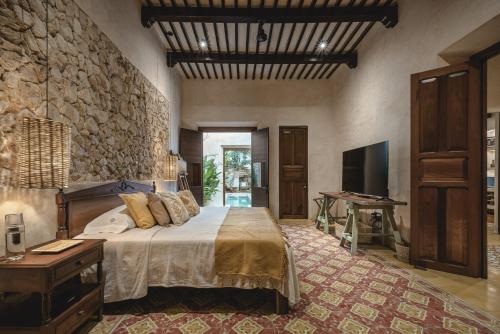 a bedroom with a bed and a television in it at Luxury Suite by La Casa Verde in Campeche