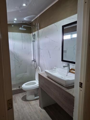 a bathroom with a sink and a toilet at Hotel MarBrissa in Puerto Barrios