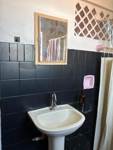 a bathroom with a sink and a mirror at Quarto confortável no Centro- Wi-Fi rápido, ar-condicionado in São Luís