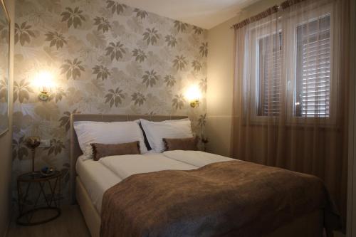 a bedroom with a large bed and a window at LadyM in Rabac