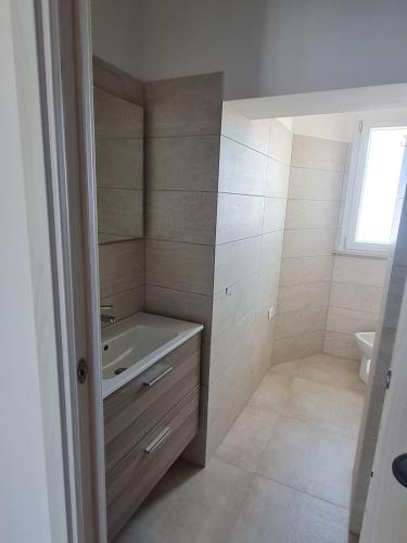 a bathroom with a tub and a sink and a toilet at Le 2TORRI in Falconara Marittima