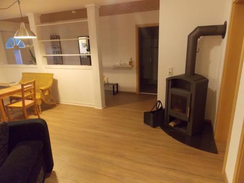 a living room with a wood stove in it at Römischer Gutshof in Laufenburg
