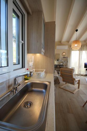 a kitchen with a sink and a large window at Amanda's House in Poros