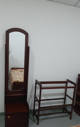 a mirror and a dresser next to a bed at Thoughtfully Updated 1960s Jaffna House in Jaffna