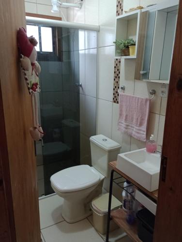 a bathroom with a toilet and a shower and a sink at Pousada Nilda in Pântano Grande