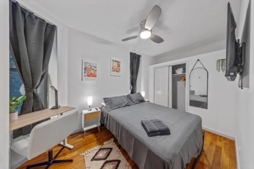 a bedroom with a bed and a desk and a window at Double Room with shared bathroom in Times Square in New York