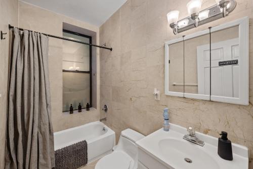 a bathroom with a sink and a toilet and a tub at Double Room with shared bathroom in Times Square in New York