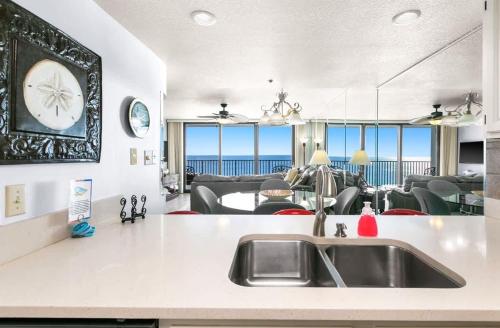 a kitchen with a sink and a clock on the wall at One Seagrove Place 1505 in Santa Rosa Beach