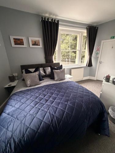 a bedroom with a blue comforter on a bed at New Crown Inn Bath in Bath