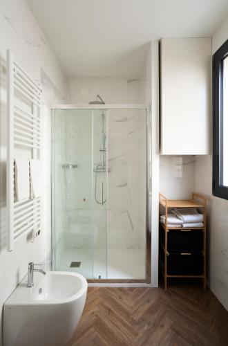 a bathroom with a glass shower and a sink at Residence Atlantico in Lido di Jesolo