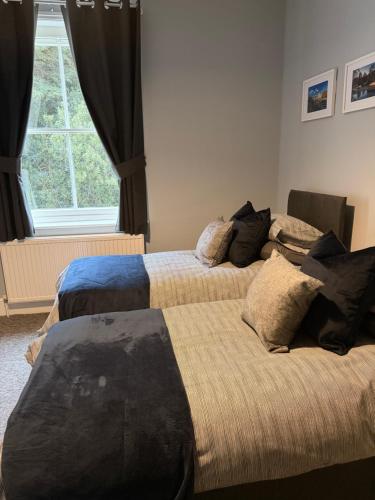 a bedroom with two beds and a window at New Crown Inn Bath in Bath