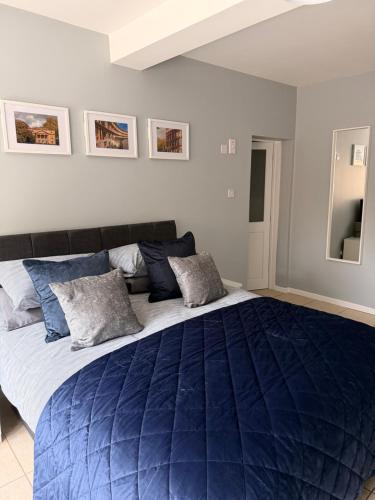 a bedroom with a large bed with a blue comforter at New Crown Inn Bath in Bath
