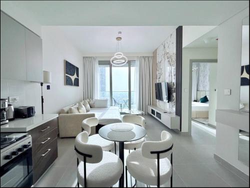a kitchen and living room with a table and chairs at Private Room in Premium Burj Vista Downtown Apartment with Burj Khalifa View in Dubai