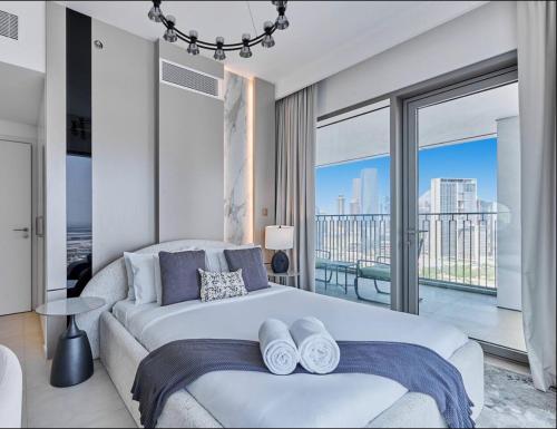 a bedroom with a large bed and a large window at Private Room in Premium Burj Vista Downtown Apartment with Burj Khalifa View in Dubai