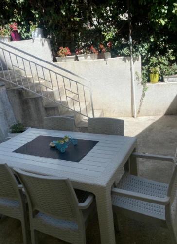 a white table with chairs and a plate on it at Galeb Apartment Ohrid in Ohrid