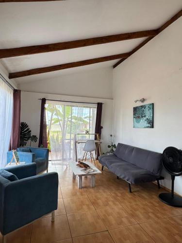 a living room with two couches and a table at Manu Kehu in Hanga Roa