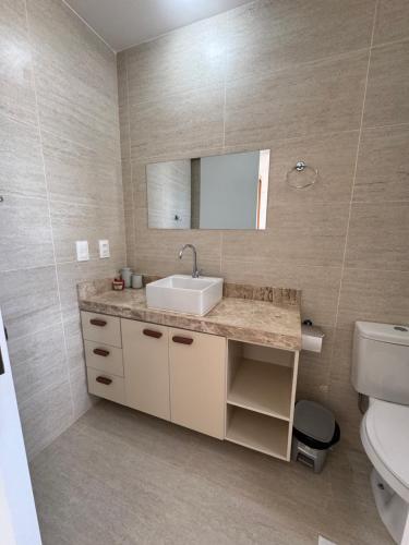 a bathroom with a sink and a toilet at Apto Areia Branca Canoa Quebrada in Canoa Quebrada