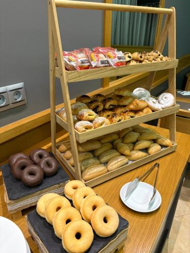a display of different types of donuts on a table at Hotel Teruel in Vinarós