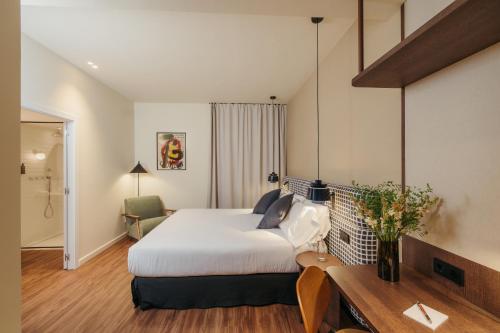 a hotel room with a bed and a desk at H Regas Adults Only in Barcelona