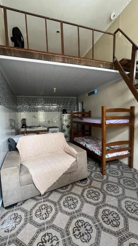 a bedroom with a bed and a loft at Pousada Biribiri in Salvador