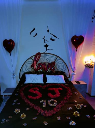 a bedroom with a bed with two hearts on it at Le relax & vous in La Louvière