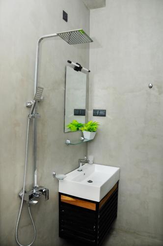 a bathroom with a sink and a mirror at Sky Haven in Matara