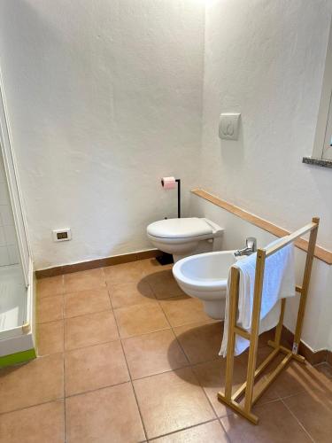 a bathroom with a toilet and a sink at Dimora Farnese in Piacenza