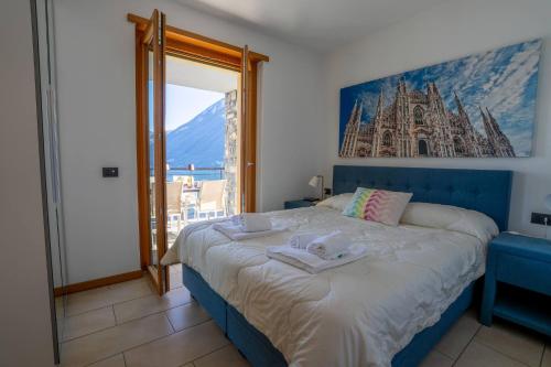 a bedroom with a large bed with towels on it at Residence degli Oleandri APP A1 in Argegno
