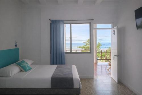 a bedroom with a bed and a view of the ocean at Hotel Montecarlo by Croma in Santiago