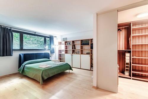 a bedroom with a bed and a large window at Villa Citriodora in Cernobbio
