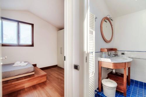 a bathroom with a sink and a bed at Villa Citriodora in Cernobbio