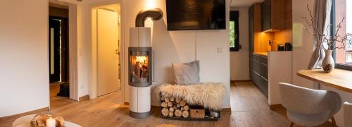 a living room with a fireplace in a kitchen at Modern Birch Chalet At Ruppberg in Zella-Mehlis