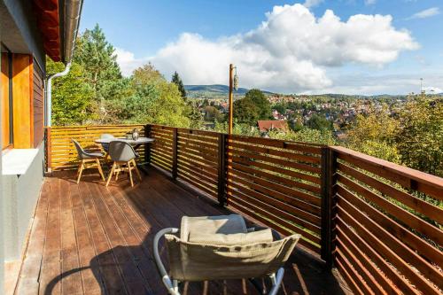 a balcony with a table and chairs and a view at Modern Birch Chalet At Ruppberg in Zella-Mehlis